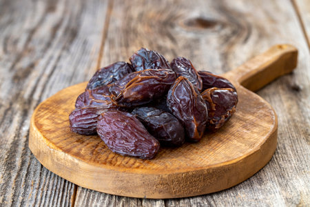 Date fruit on wood background. Organic and fresh nuts. close up