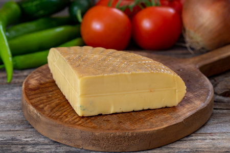 Smoked cheese on wood background