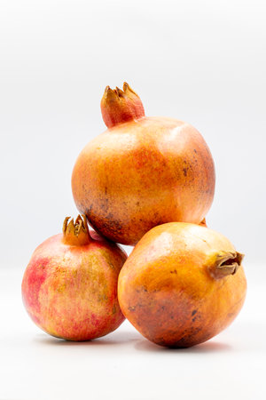 Fresh organic pomegranate fruits on a white background with shadow. close upの写真素材