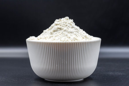Bowl of flour on black background. close-up. Horizontal view. selective focusの写真素材