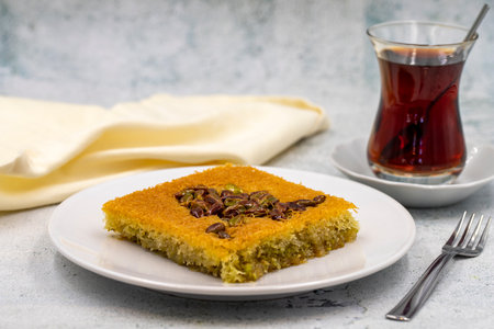 Pistachio kadayif dessert on stone background. Traditional Turkish cuisine flavor. close upの写真素材