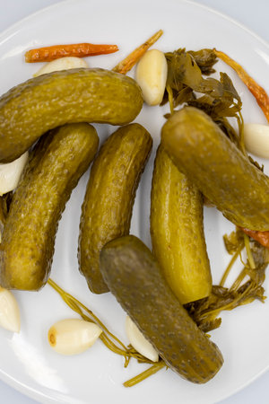 Pickled cucumbers on a white background. Close-up of pickled cucumbers in a ceramic plate. close up. Top viewの写真素材