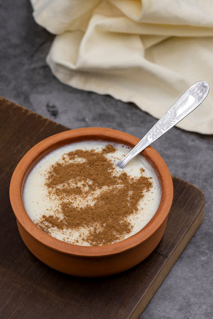 Rice pudding (Sutlac). Turkish cuisine flavor rice pudding on a dark background. close up. story...