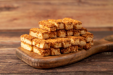 Sesame cookies. Bakery products. Salted sesame cookies on wood background. close up
