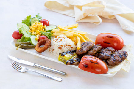 Appetizing kofta kebab (meatballs) with sauce and tortillas tacos on wooden background