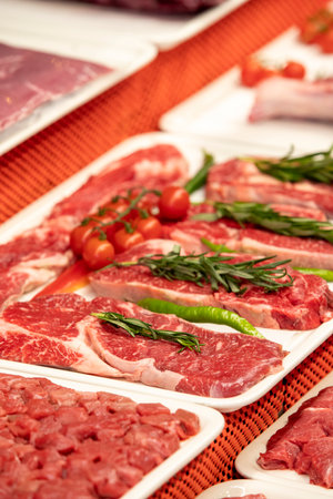Selection of quality meat in a butcher shop. Different types of fresh meat are on display. meat...