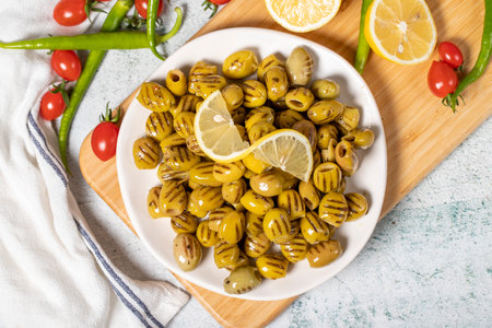 Grilled olives. Tasty Green grilled olives in the plate. healthy food. Top viewの写真素材