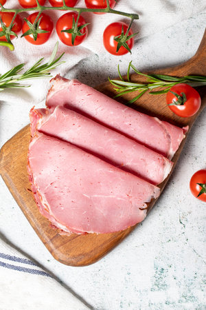 Beef salami on a wooden serving board. Dried smoked ribeye salami. Top viewの写真素材