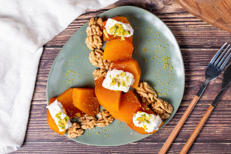 Creamy pumpkin dessert. Turkish Ramadan sweet delicacies. Pumpkin dessert with sorbet on gray background. Top viewの写真素材