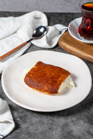 Milky dessert or Kazandibi. Traditional Turkish cuisine desserts. Kazandibi on a dark background