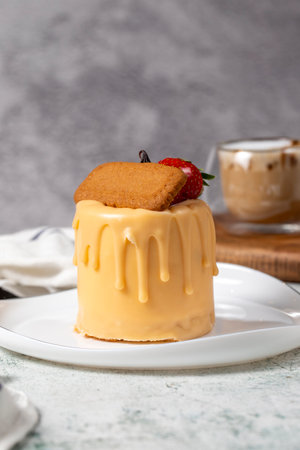 Caramel and biscuit cake. Patisserie products. Liquid caramel cake on a gray background. close upの写真素材