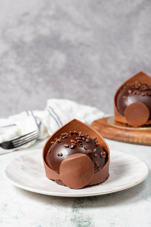 Chocolate cake. Bakery desserts. Delicious round portion cake with cream and dragee fillingの写真素材