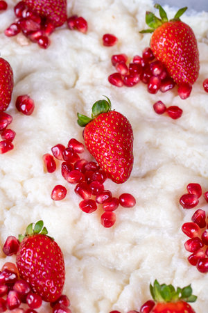 Gullac dessert. Traditional Ramadan dessert. Close-up of gullac dessert with pomegranate and strawberryの写真素材