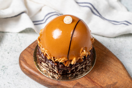 Round caramel cake. Hazelnut and cream portion cake. close up.の写真素材