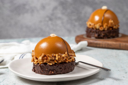 Round caramel cake. Hazelnut and cream portion cakeの写真素材