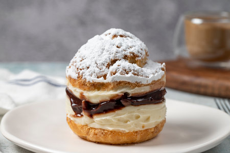 Cake with cream and liquid chocolate filling. Powdered Sugar Cake. close up.の写真素材