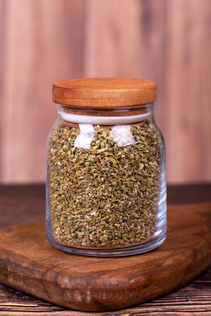 Thyme spice. Dried Thyme leaf in glass jar on wood background. Spice concept.の写真素材