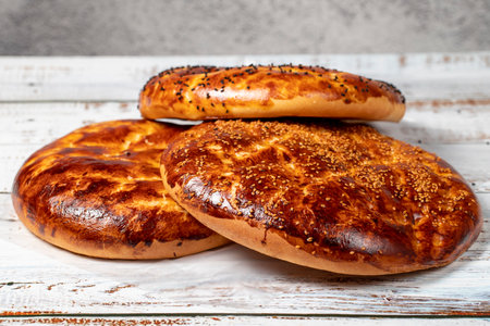 Sesame ramadan pita on a wood floor. Ramadan delicacies. Pita bread special for the month of...