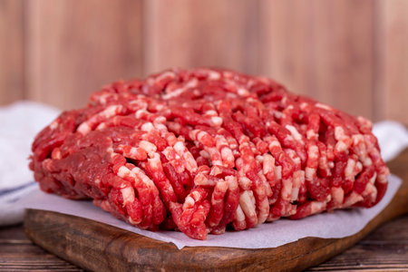 Minced meat on wood background. Raw minced cow meat or ground meat. close upの写真素材