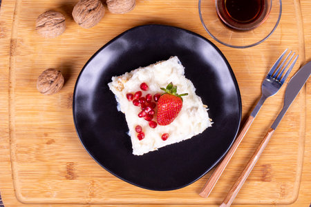 GÃ¼llaÃ§ dessert with pomegranate and strawberry. Ramadan dessert. Gullac dessert with walnuts...