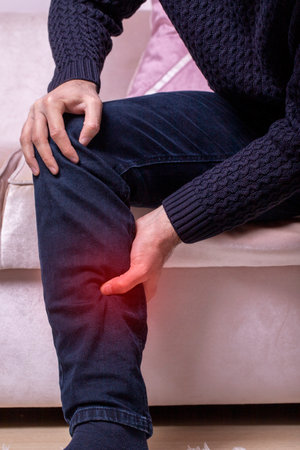Man with leg calf pain. The man's calf muscle cramped, massage of male leg at home, painful area...