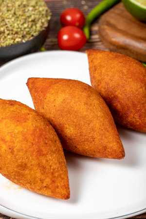 Turkish stuffed meatballs. Arabian and Turkish cuisine flavored icli kofte or kibbeh on a wood...