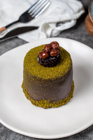 Chocolate cake. Cake with pistachio and chocolate cream on a dark background. patisserie desserts. close upの写真素材