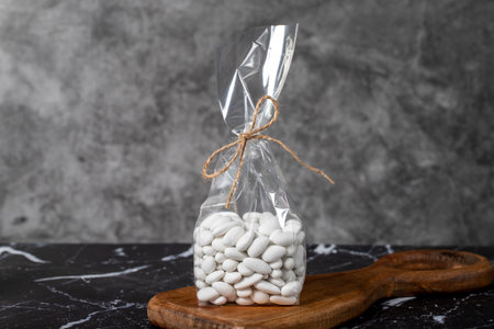 Packed Almond Candy. Snack chocolate covered marzipan on dark background. local name almond sugar