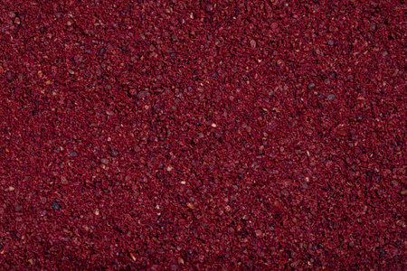 Close-up sumac background. Dried ground red Sumac powder spices. Spices concept. Spice background....