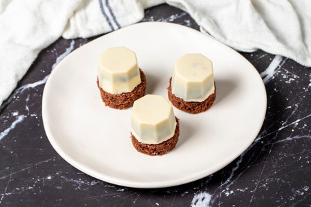 Cookies covered in white chocolate. Liquid chocolate chip cookies on a dark backgroundの写真素材