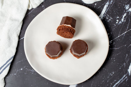 Cookies covered in milk chocolate. Liquid chocolate chip cookies on a dark background. Top viewの写真素材