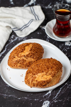 Sesame and cheese pastry on dark background. Turkish street food. Cheesy pastry. close up