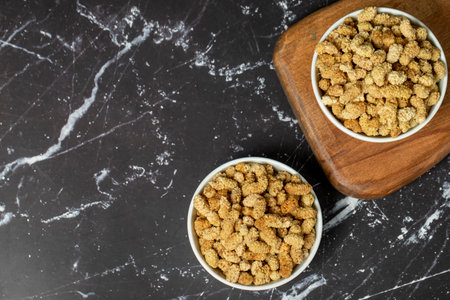 dried mulberry Sun-dried mulberry in ceramic bowl. superfood Vegetarian food concept. healthy snacks. Top view. Copy space. Empty space for textの写真素材