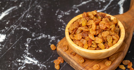 raisins Sun-dried grapes in wooden bowl. superfood Vegetarian food concept. healthy snacks. close upの写真素材