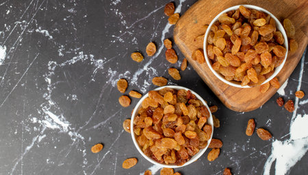 Raisins. Sun-dried grapes in ceramic bowl. superfood Vegetarian food concept. healthy snacks. Top view. Copy space. Empty space for textの写真素材