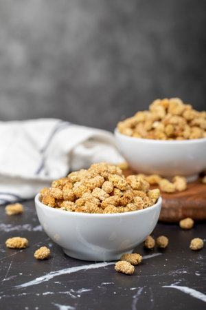 dried mulberry Sun-dried dried mulberry in ceramic bowl. superfood Vegetarian food concept. healthy...