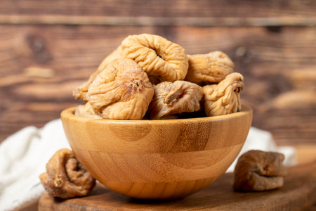 Dried figs in bowl. Organic farm products. Sun-dried figs on dark background. close upの写真素材