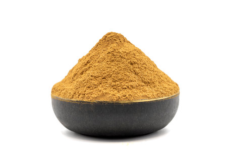 Cinnamon powder isolated on white background. Powdered dried cinnamon in bowlの写真素材
