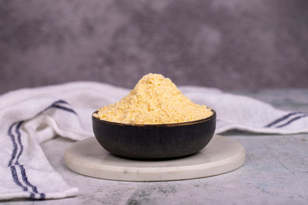 Corn flour on stone background. Cornmeal in bowl. close upの写真素材