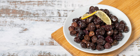 black olives Fermented olives and lemon slice in plate. Mediterranean flavors. Copy space. Empty space for textの写真素材