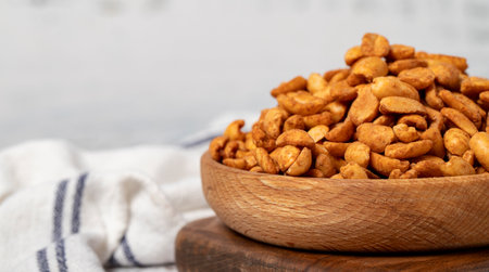 Peanuts with sauce in wooden bowl. Peanuts with sauce on a white wood background. Copy space. Empty space for textの写真素材