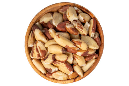 Brazil nut in wood bowl. Brazilian nuts peeled isolated on white background. top viewの写真素材