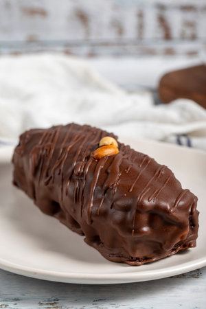 Chocolate and peanut cake. Peanut cake with fresh caramel filling on a plate. Close up