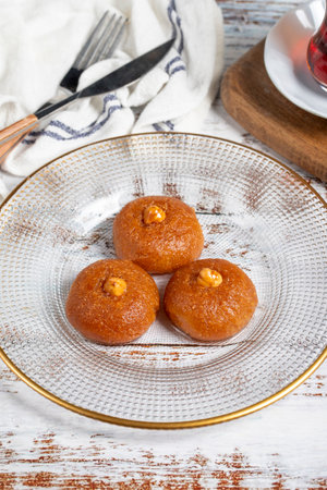 Sekerpare or badempare dessert on a white wood background. Traditional Turkish cuisine flavors. ramadan dessertの写真素材