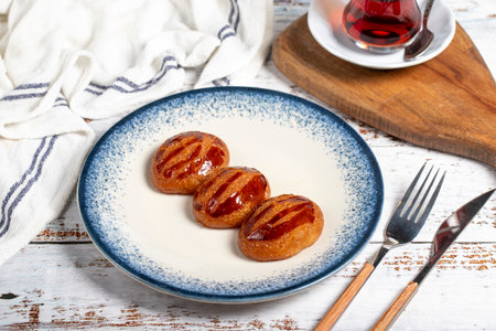Sekerpare or badempare dessert on a white wood background. Traditional Turkish cuisine flavors. ramadan dessertの写真素材