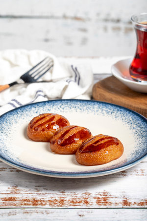 Sekerpare or badempare dessert on a white wood background. Traditional Turkish cuisine flavors. ramadan dessertの写真素材