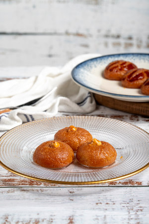 Sekerpare or badempare dessert on a white wood background. Traditional Turkish cuisine flavors. ramadan dessertの写真素材