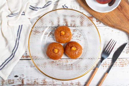 Sekerpare or badempare dessert on a white wood background. Traditional Turkish cuisine flavors. ramadan dessertの写真素材