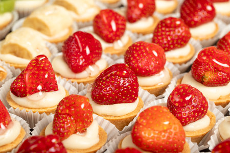 Tartlet types. Pastry product. Tartlets with kiwi, banana and strawberry on a white background. localname. Close upの写真素材