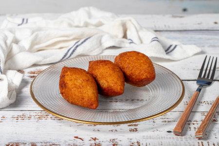 Stuffed meatballs or kibbeh. Traditional Asian flavours. Delicious meatballs filled with minced meat. Kibbeh on white wood background. local name kibbehの写真素材